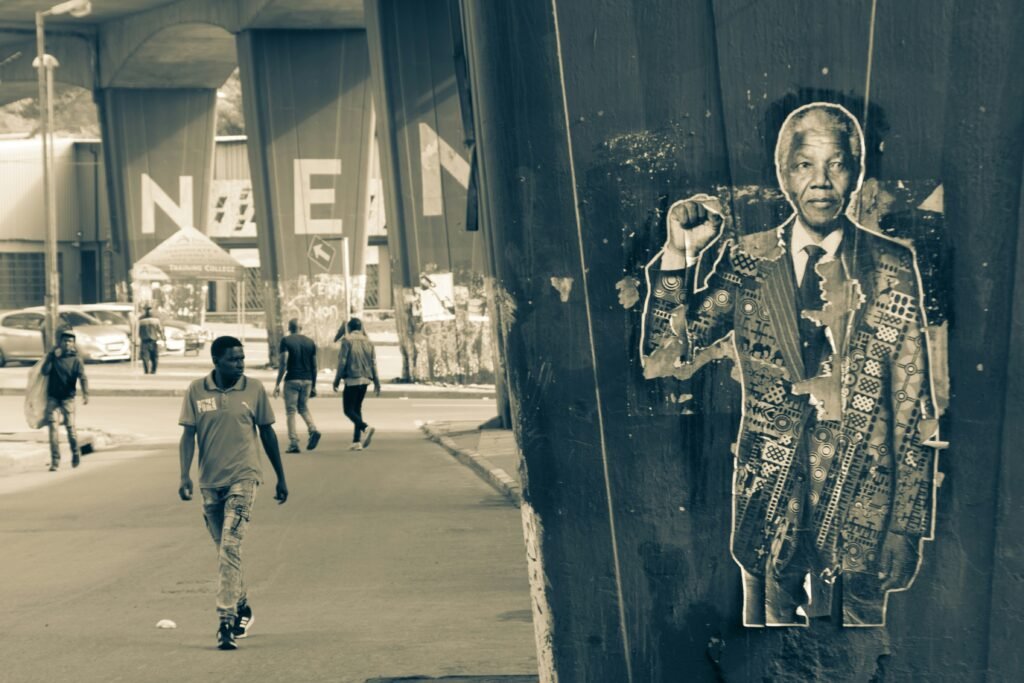 Nelson Mandela stands as an emblem of resilience, justice, and reconciliation